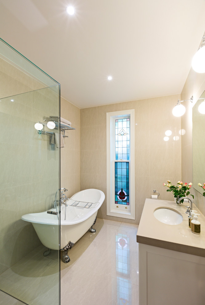 a beige and creamy bathroom with bubble lamps and a modern glass clad shower space (Period Extensions & Designs)