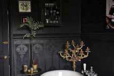 a dramatic bathroom design with black walls