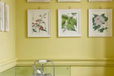 a stylish bathroom with a botanical gallery wall