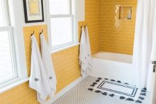 a cheerful bathroom with yellow tile walls, a penny tile floor and white appliances for a chic look