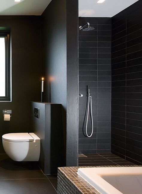 a contemporary black bathroom with skinny tiles and matte walls, white applainces and stainless steel fixtures is amazing