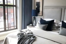 a dove grey bedroom with bold blue touches shows off luxury and beauty