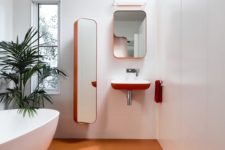 a minimalist bathroom with an orange penny tile floor and orange edges is a bold and chic idea