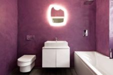 a minimalist bathroom with purple walls, a wooden floor and white appliances and a catchy shaped mirror