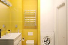 a minimalist sunny yellow and white bathroom with a color block effect and a floating vanity plus a built-in washing machine