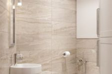 a modern bathroom done in beige and tan and touches of white, with porcelain tiles