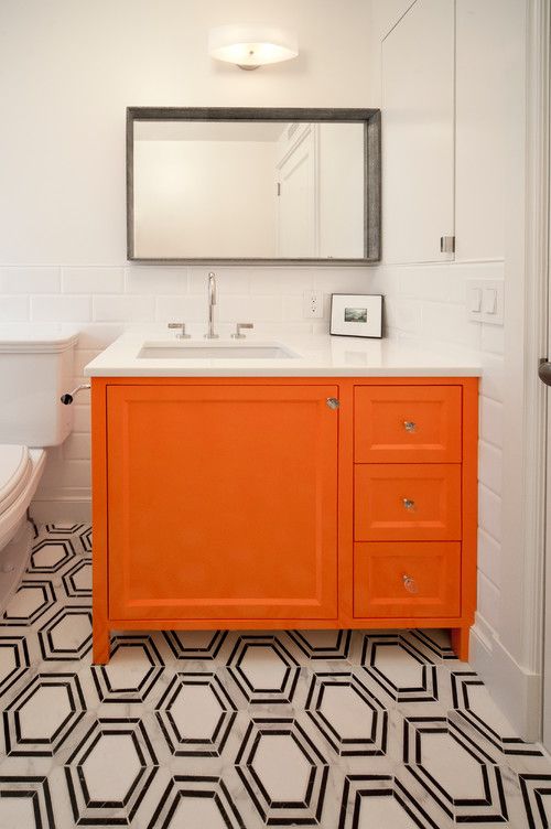 A monochromatic bathroom spiced up with a bright orange vanity   just repaint your existing one and voila