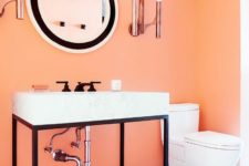 a monochromatic black and white bathroom with an accent light orange wall that makes a statement in the space