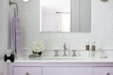a romantic bathroom with a lavender vanity, a white stone countertop, metallic touches is a beautiful space
