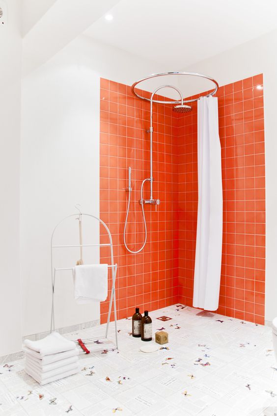 accent your shower space with bright orange tiles and white grout and keep everything else neutral for a modern feel