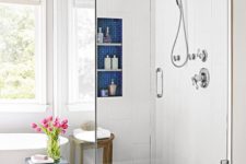 bright blue tile touches – shower floors, a niche for storage and an elegant side table