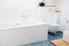 geometric blue tiles on the floor will add a touch of color and chic to the bathroom