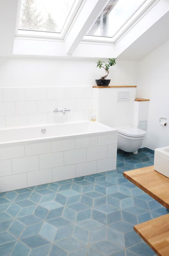 geometric blue tiles on the floor will add a touch of color and chic to the bathroom