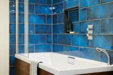 give your walls the the wow factor with intense blue and glossy finish, add a wooden clad bathtub