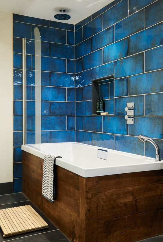 give your walls the the wow factor with intense blue and glossy finish, add a wooden clad bathtub
