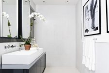 modern bathroom design in black and whtie color theme with a nice vessel sink and a large photo