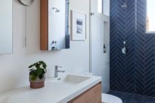 navy blue ceramic tiles in herringbone pattern on bathroom wall and floor for a contemporary rustic bathroom