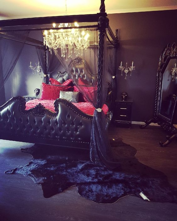a chic Gothic bedroom with black walls, a show-stopping black canopy bed with gauze, crimson bedding and crystal lamps (photo by little_lady_wolf)