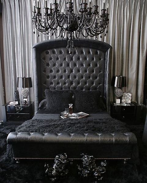 a refined Gothic bedroom with a black leather bed, glossy nightstands, a refined black chandelier and elegant detailing