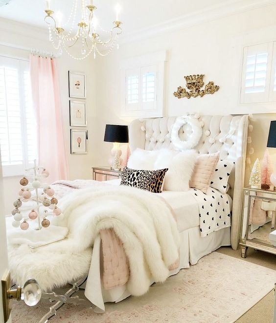 a refined glam bedroom in neutrals and pink, with black dramatic touches, gold items and faux fur