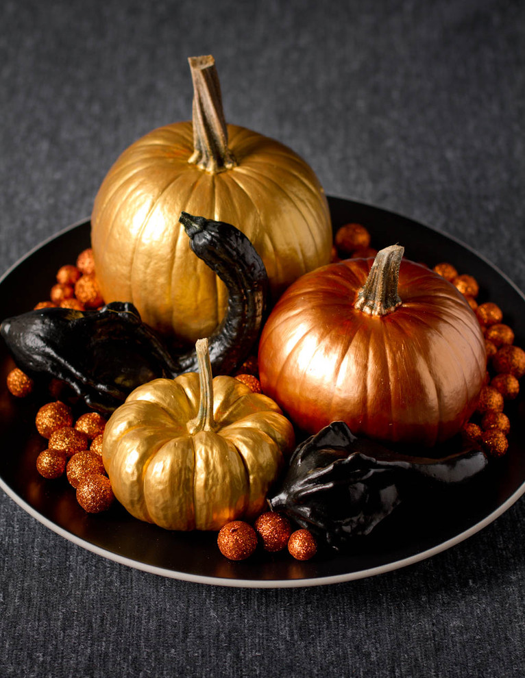 Paint your pumpkins with a shiny paint to add a warm glow to your decor.