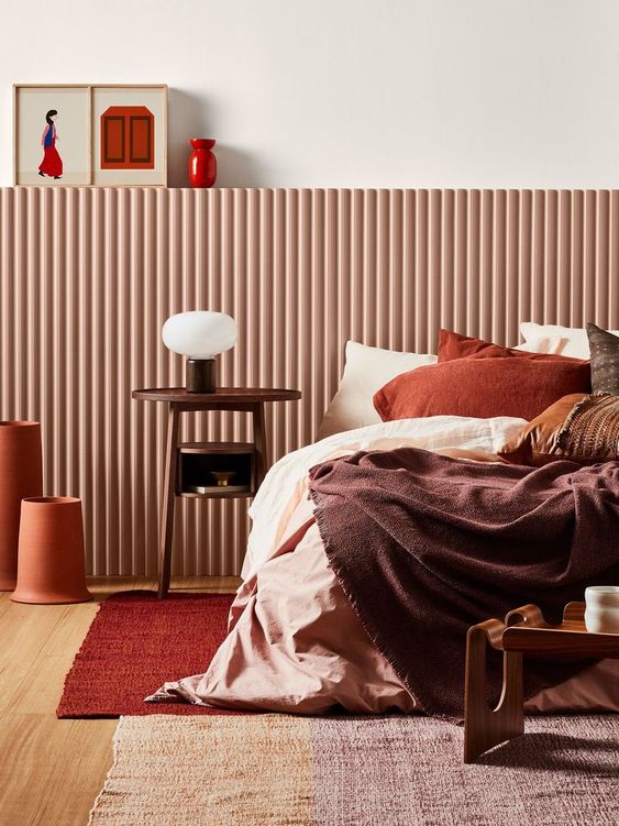A bold fall colored bedroom done with a palette of chocolate brown, rust, burgundy and deep red