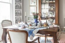 a fantastic French country dining room with wall-mounted shelves, a stained glass cabinet, a stained table and neutral chairs