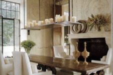 a refined French country dining room with a non-working fireplace, a dark-stained table and neutral chairs and stools