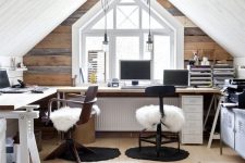 a shared rustic attic home office with a reclaimed wood accent wall, a corner desk, stained chairs, faux fur and pendant lamps