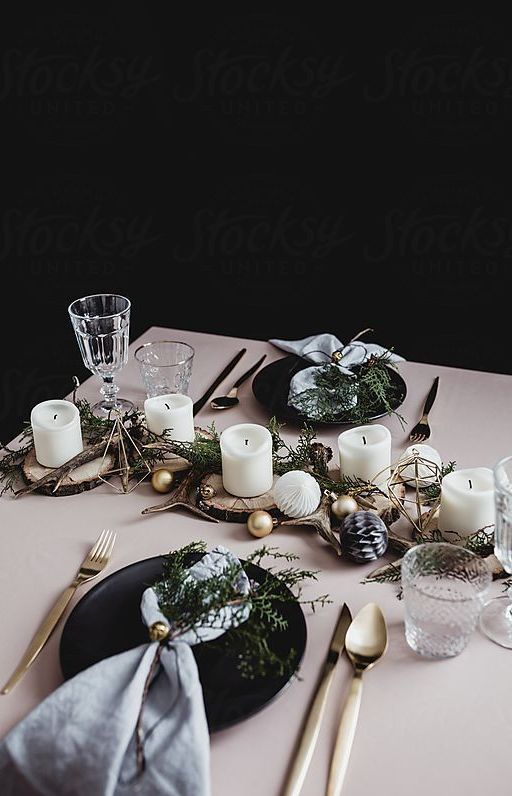 black plates, metallic cutlery, ornaments, wood slicesm branches, pillar candles paper balls