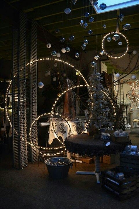 Holla hoops with string lights and Christmas ornaments would be cool for any outdoor holiday arrangement.