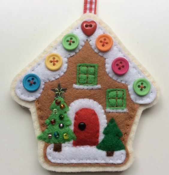 a colorful felt Christmas ornament with bright beads showing off a house with tiny Christmas trees is a lovely idea