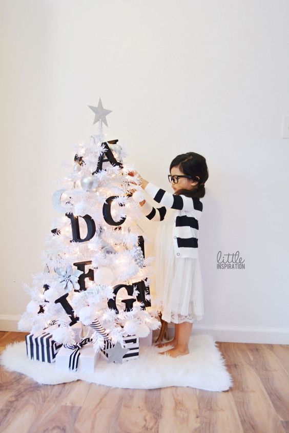 a little white tree with black monogram letters to teach your kid the alphabet