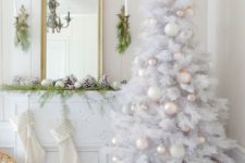 a pure white Christmas tree with tender pastel and white ornaments and bead garlands is a chic idea