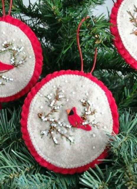 a red and white round Christmas ornament with beads and a bird applique is a bold and chic idea to rock