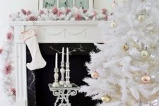 all-white Christmas tree with pastel metallic ornaments looks chic and refined