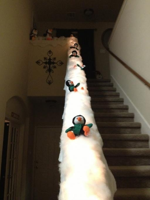 Turning staircase's banister into penguins sled is a great idea for those who want to make your decor more fun.