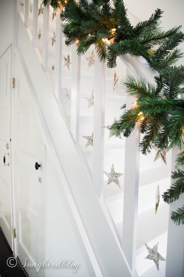 Folded music sheet stars are a great way to spice up a simple garland on a staircase.