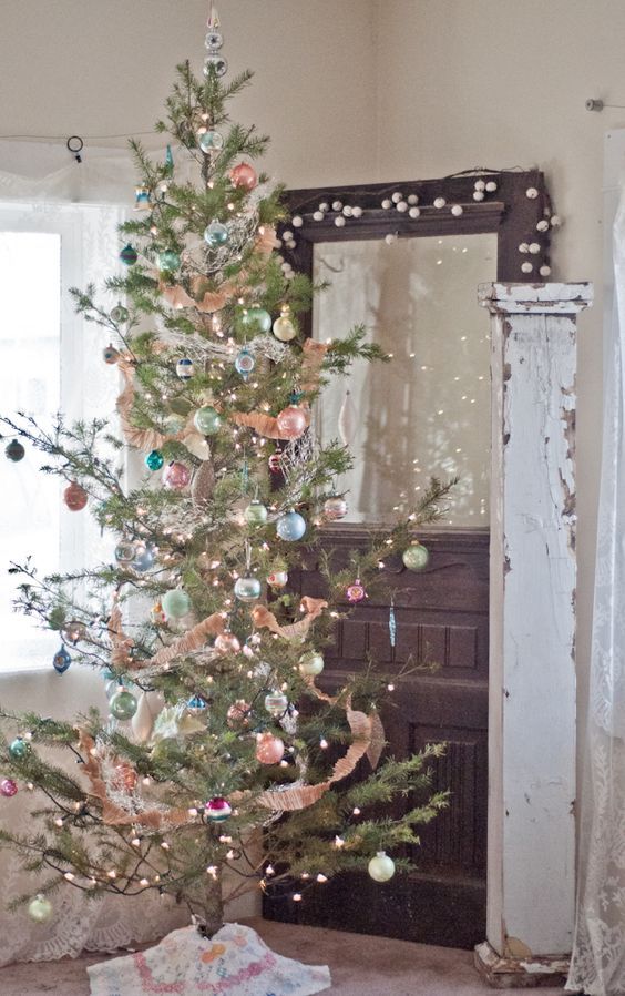 a Christmas tree with lights and pastel ornaments of various colors for a chic vintage feel