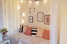 a canopy with lighting on one side of the bed and over it, too