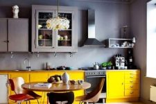 a stylish moody kitchen with yellow touches