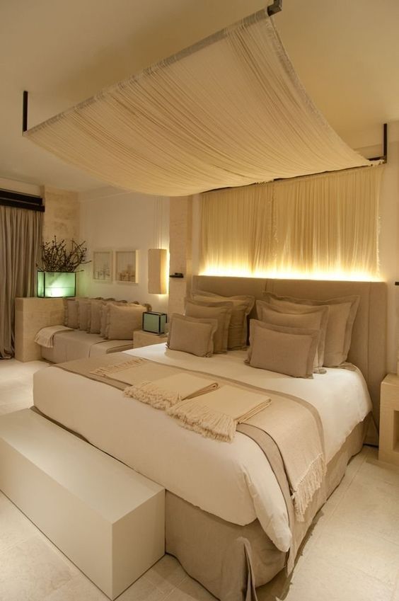 a light fabric canopy and lights over the headboard for a chic look