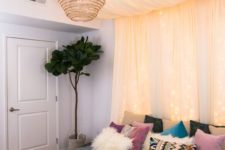 a pastel canopy with lights over the bed plus a wicker lampshade for a boho look