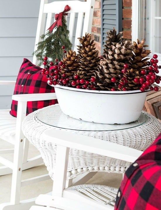 a white bathtub with oversized pinecones, berries is a bold outdoor Christmas decoration to go for