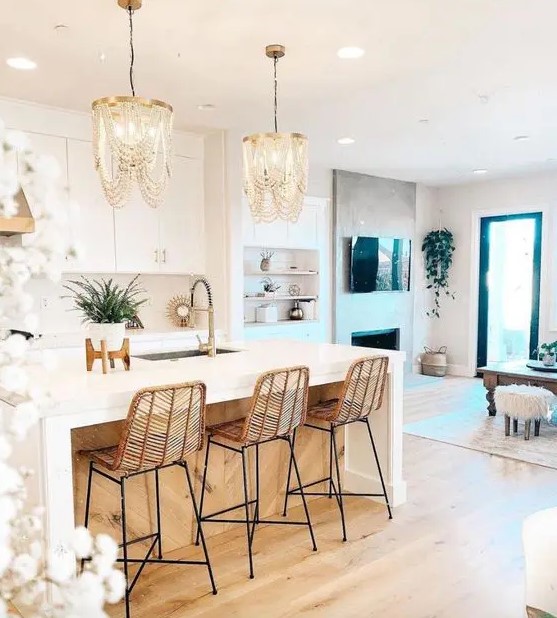amazing wooden bead chandeliers, rattan stools make this white kitchen glam, chic and very outstanding
