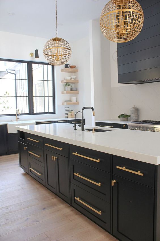 gold wire globe pendant lamps on chain highlight the contrasting black and white kitchen and accent the space a lot