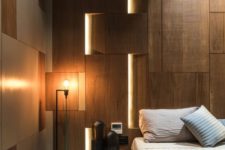 lights integrated into the wall panels make the space look modern and bold