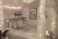 sheer fabric canopy with lights and lights over the bed for a chic and romantic look