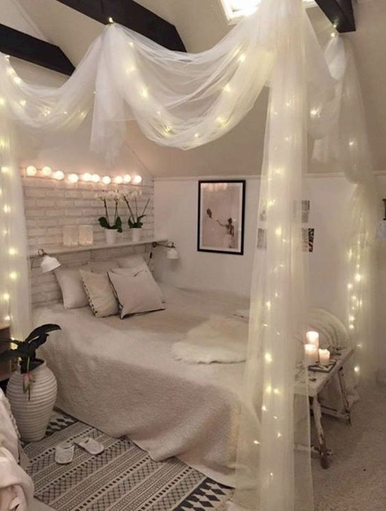 sheer fabric canopy with lights and lights over the bed for a chic and romantic look