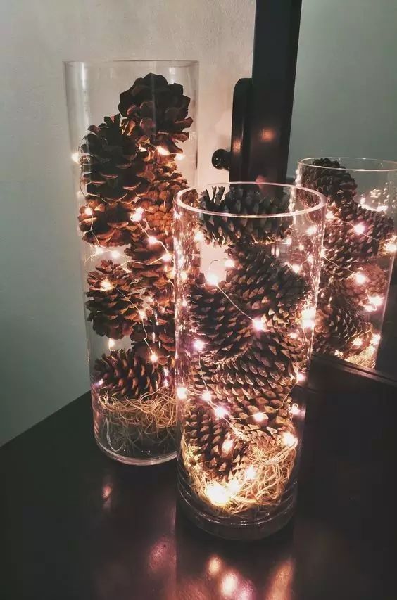 tall vases with pinecones and lights are a great rustic Christmas decoration or centerpiece